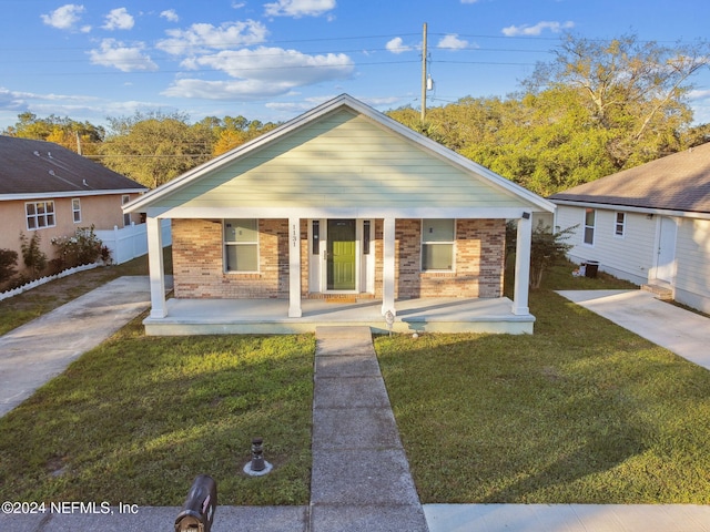 bungalow-style home with a front lawn and a porch