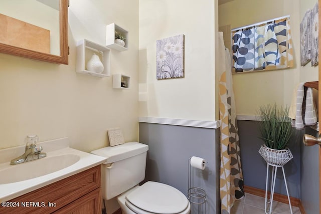 bathroom featuring tile patterned floors, vanity, and toilet