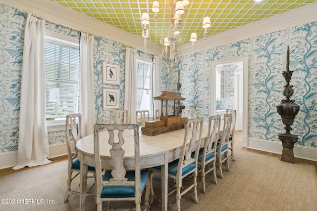 dining area with a healthy amount of sunlight, crown molding, and a chandelier