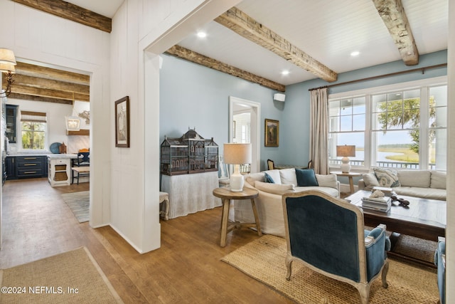 living room with beamed ceiling and hardwood / wood-style flooring