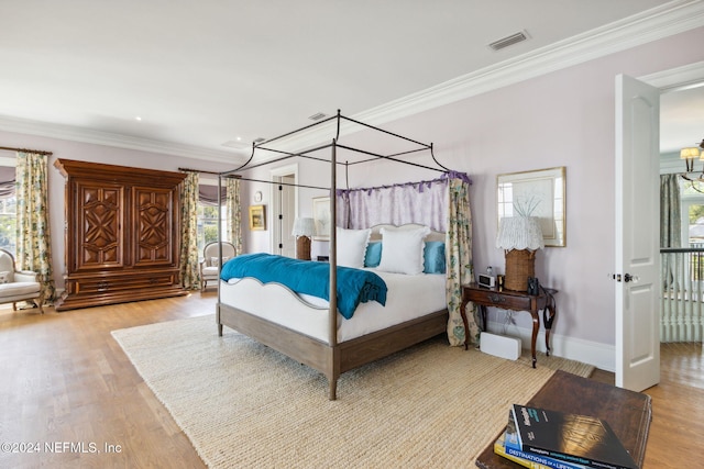 bedroom with light hardwood / wood-style flooring and multiple windows