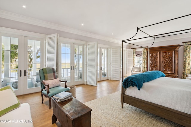 bedroom featuring access to exterior, crown molding, french doors, and light hardwood / wood-style flooring