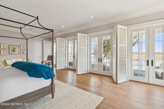 bedroom featuring access to exterior, crown molding, french doors, and light hardwood / wood-style floors