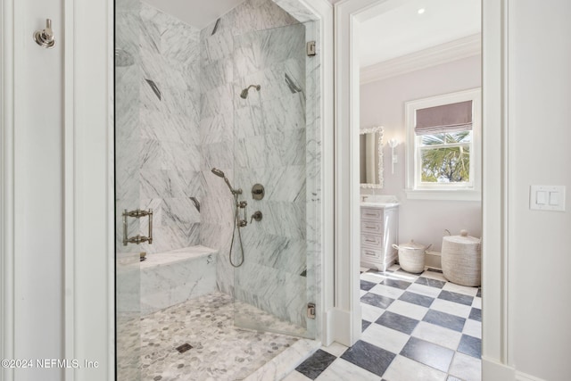 bathroom featuring vanity, a shower with shower door, and ornamental molding