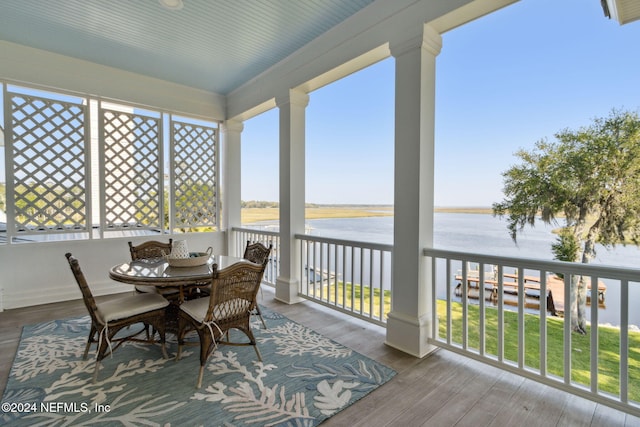 sunroom / solarium with a water view