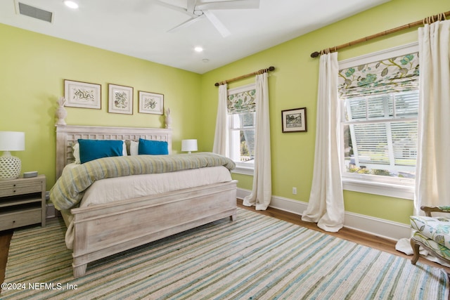 bedroom with hardwood / wood-style floors and ceiling fan