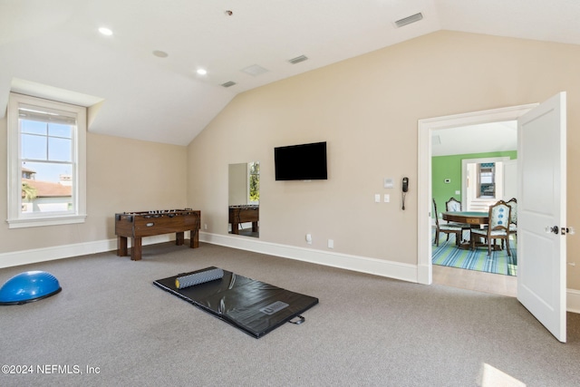 workout room featuring carpet and lofted ceiling