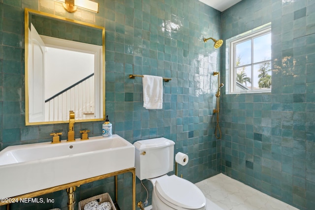 bathroom with sink, tile walls, and tiled shower