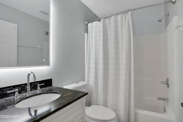 full bathroom featuring vanity, shower / bath combination with curtain, and toilet