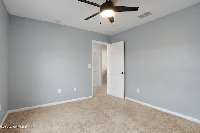 unfurnished room with light carpet and ceiling fan