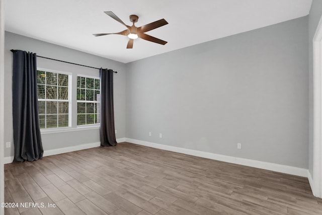 spare room featuring ceiling fan and light wood-type flooring