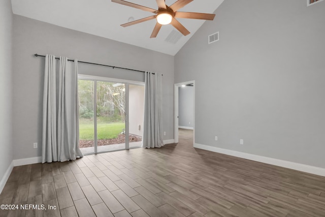 empty room with light hardwood / wood-style flooring, high vaulted ceiling, and ceiling fan