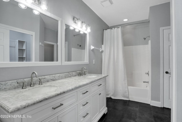 bathroom featuring tile patterned flooring, vanity, and shower / bath combo with shower curtain