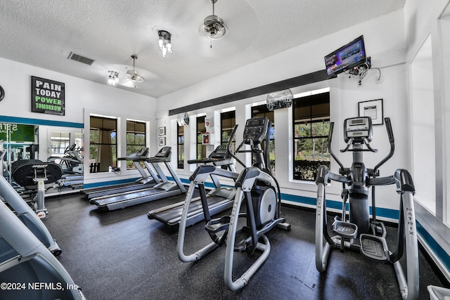 exercise room featuring a textured ceiling