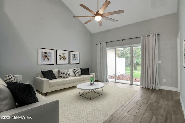 living room featuring wood-type flooring, ceiling fan, and high vaulted ceiling