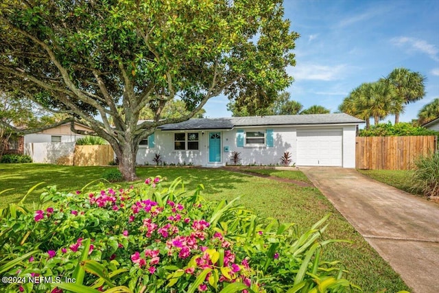 ranch-style home with a front yard and a garage