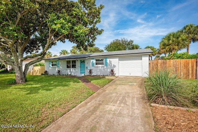 single story home featuring a front yard and a garage