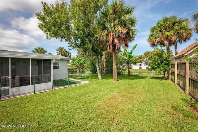 view of yard with a sunroom