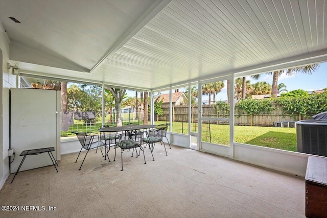 unfurnished sunroom with vaulted ceiling and a healthy amount of sunlight