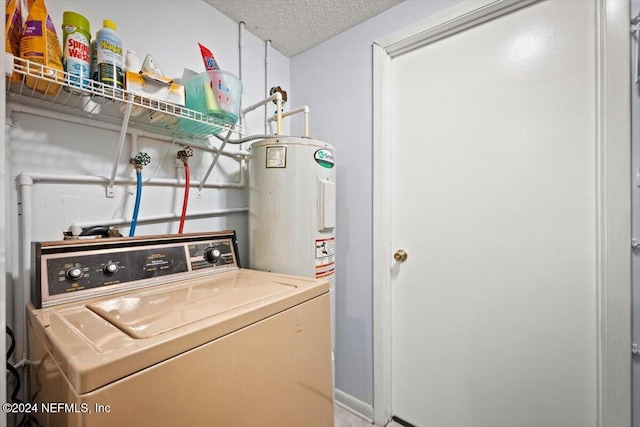 washroom with electric water heater, a textured ceiling, and washer / clothes dryer