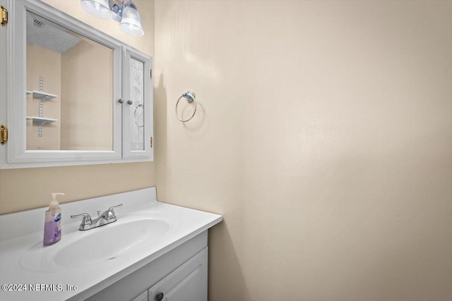 bathroom with vanity and a textured ceiling