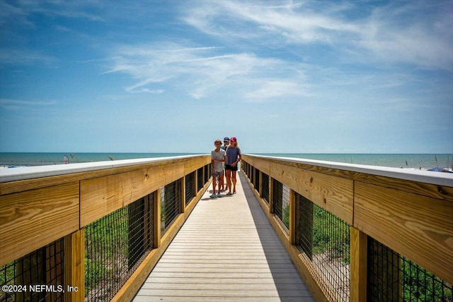 view of property's community with a water view and a view of the beach