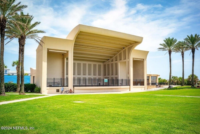 rear view of property featuring a lawn