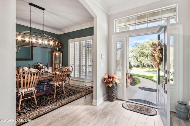 foyer entrance featuring hardwood / wood-style floors, a notable chandelier, and ornamental molding