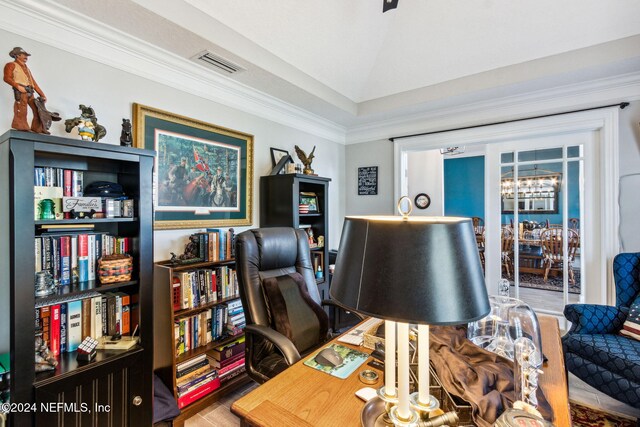 office space featuring wood-type flooring, ornamental molding, and an inviting chandelier