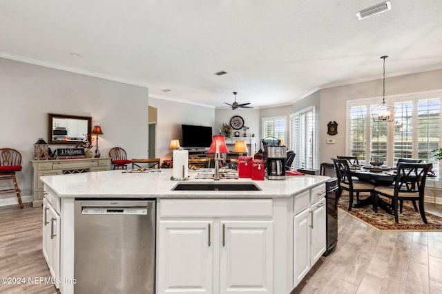 kitchen with stainless steel dishwasher, a wealth of natural light, and an island with sink