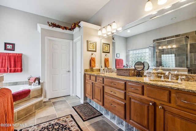 bathroom featuring tile patterned floors, vanity, and shower with separate bathtub