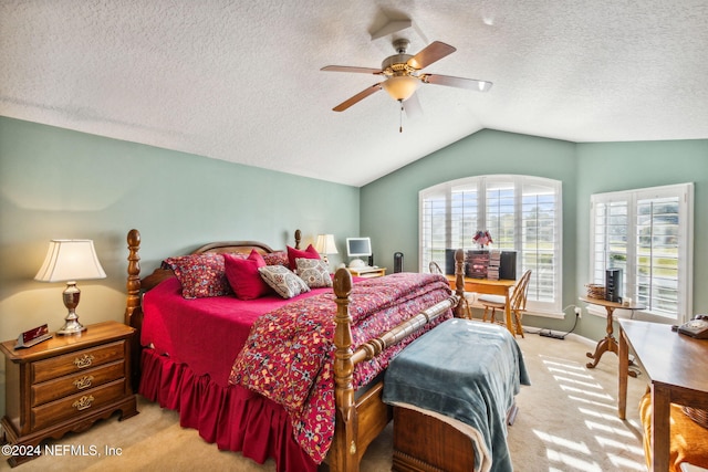 carpeted bedroom with a textured ceiling, vaulted ceiling, and ceiling fan