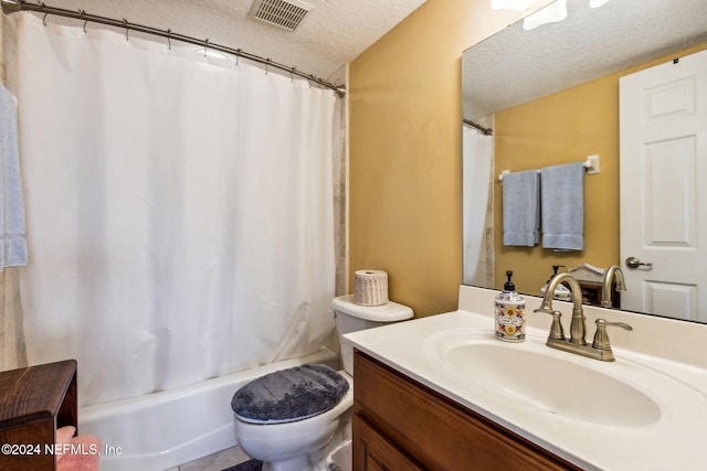 bathroom featuring vanity, toilet, and a textured ceiling