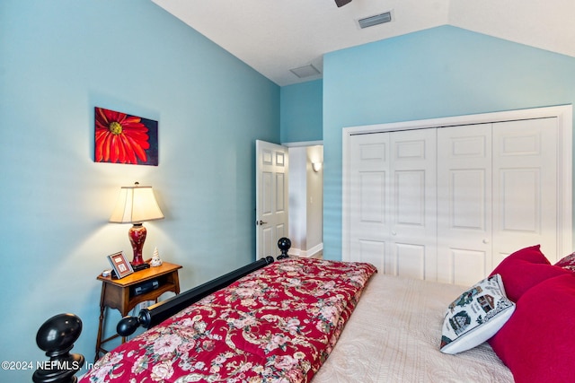 bedroom with vaulted ceiling and a closet