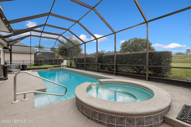 view of swimming pool featuring a lanai, a patio area, and an in ground hot tub