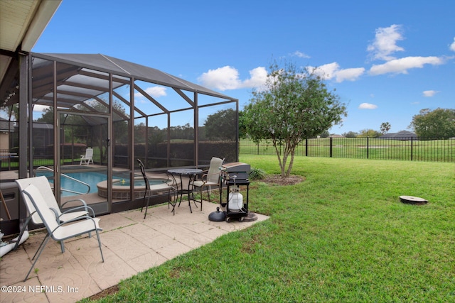 view of yard with glass enclosure, a patio area, and a pool with hot tub