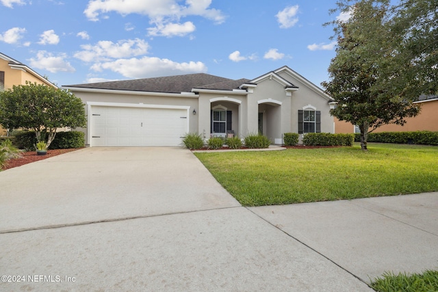 view of front of property featuring a garage and a front lawn