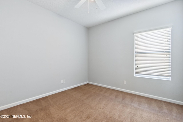 unfurnished room featuring ceiling fan, carpet floors, and a textured ceiling