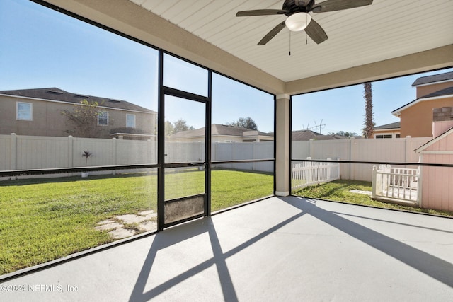 unfurnished sunroom featuring plenty of natural light and ceiling fan