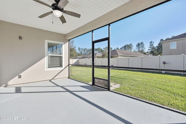 unfurnished sunroom with ceiling fan