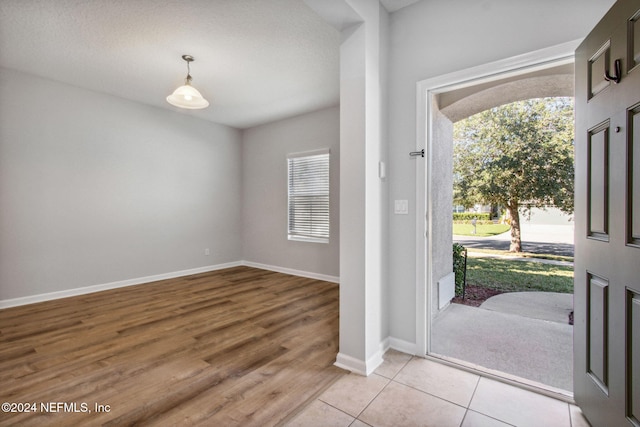 foyer featuring light hardwood / wood-style floors and a textured ceiling