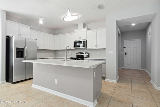 kitchen featuring white cabinetry, stainless steel appliances, and a kitchen island with sink