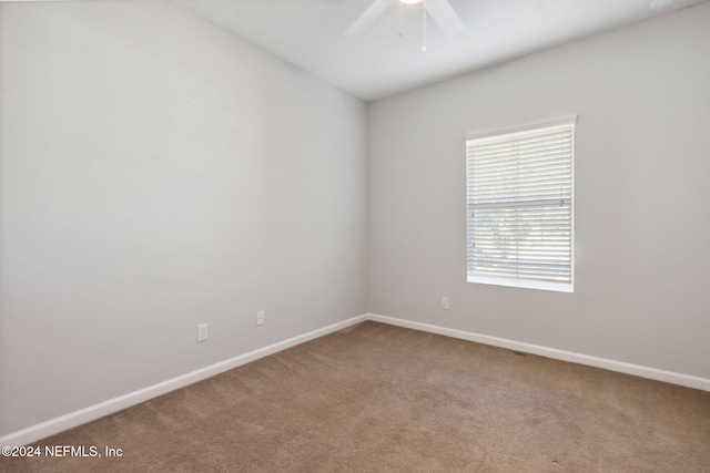 unfurnished room with carpet and ceiling fan