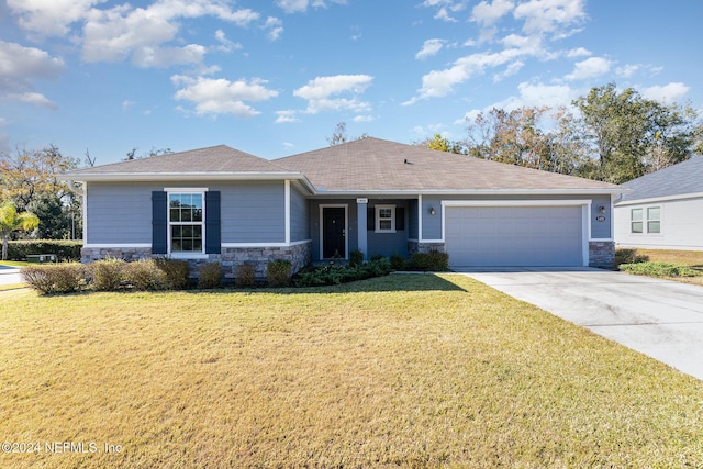 view of front of property with a garage and a front yard