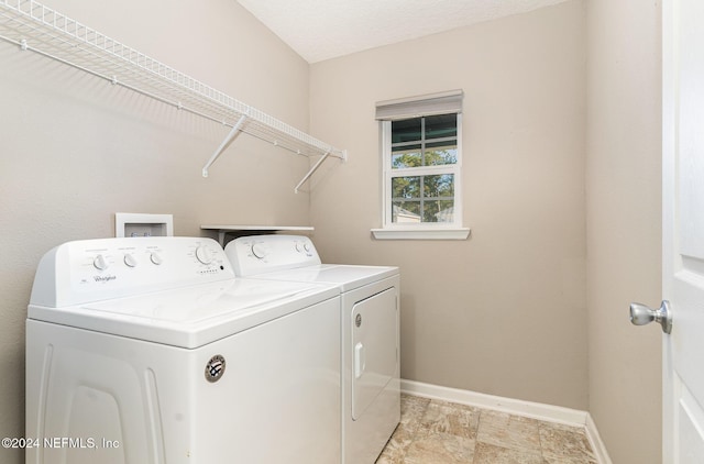 laundry area featuring washer and dryer and a textured ceiling