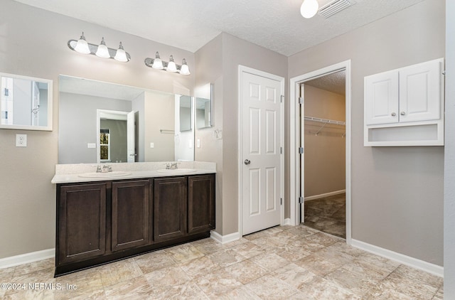 bathroom with vanity and a textured ceiling