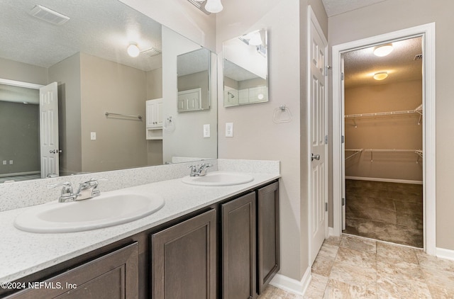 bathroom with vanity and a textured ceiling