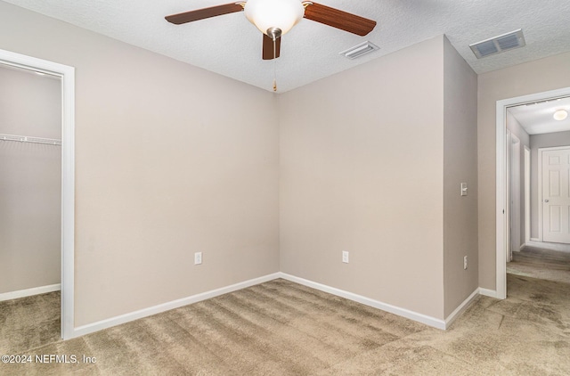 interior space featuring ceiling fan and a textured ceiling