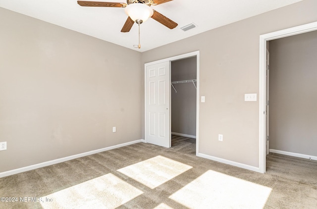 unfurnished bedroom with ceiling fan, a closet, and light colored carpet