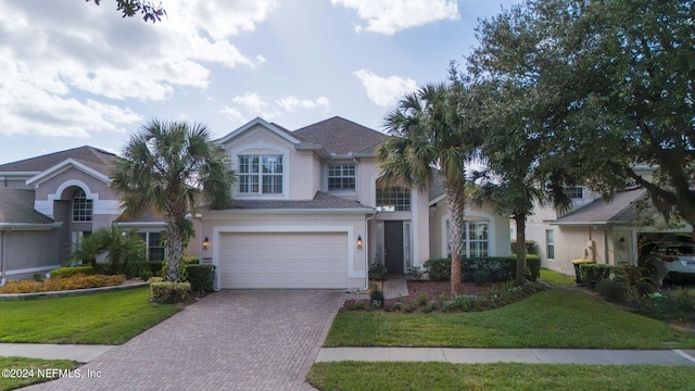 view of front of home featuring a garage and a front lawn